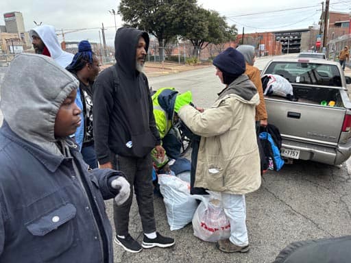 Volunteers hand out winter coats to neighbors in need