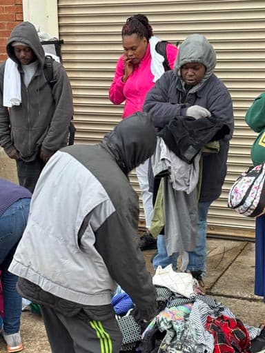 Volunteers sort through donated garments