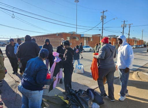 Volunteers pass out clothing to the community