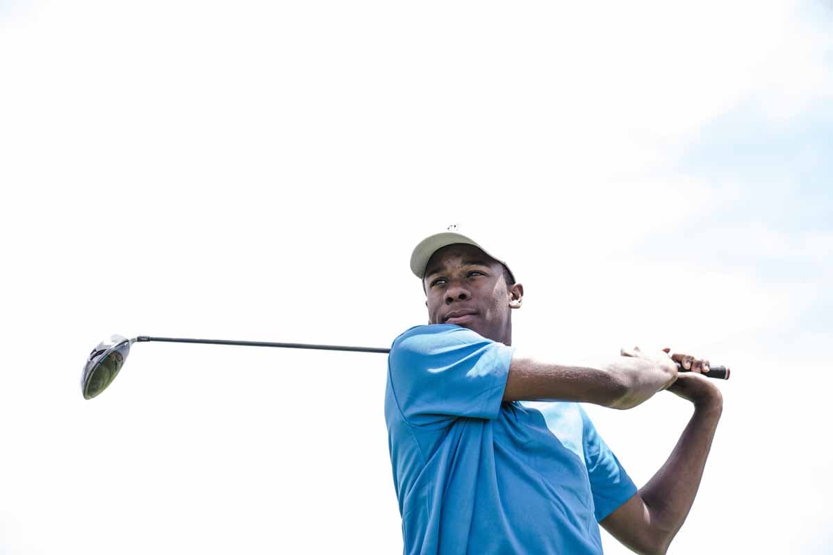 Golfer mid-swing on the tee